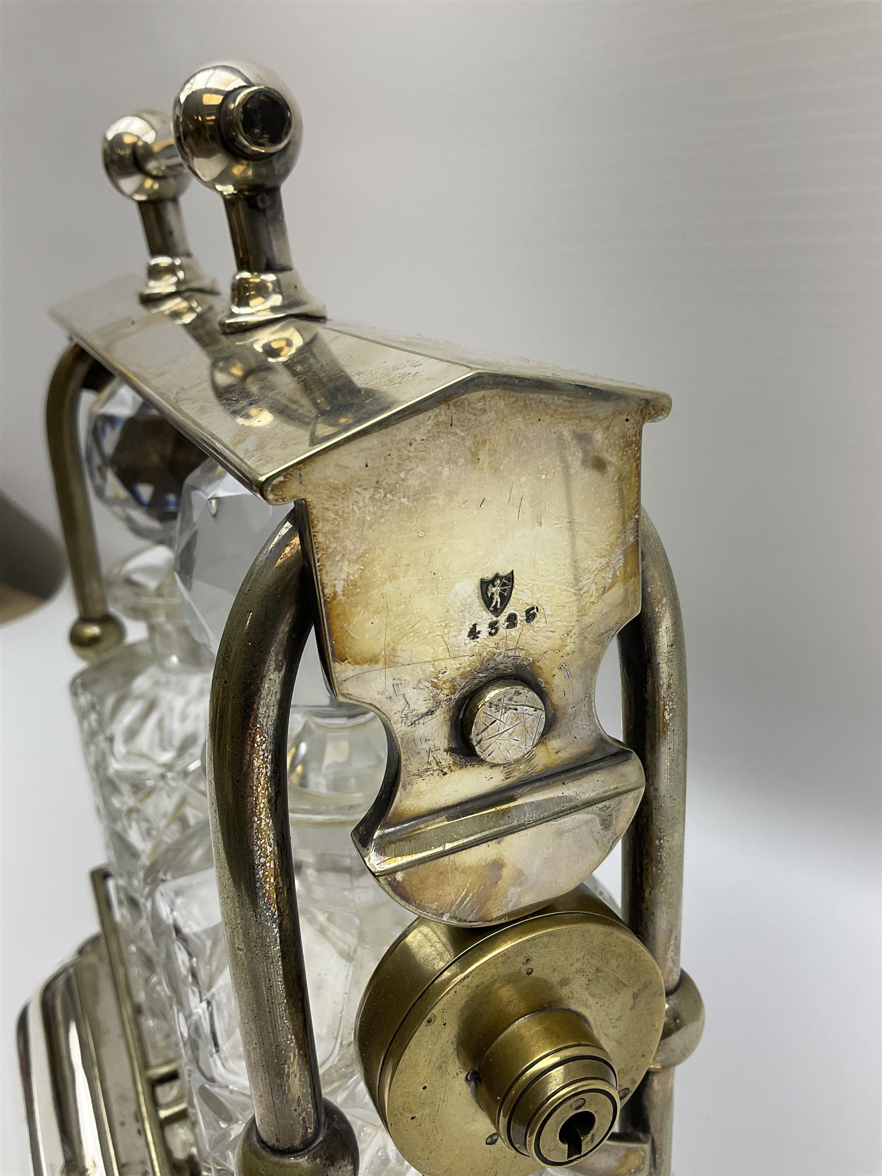 Early 20th century silver plated tantalus by John Grinsell & Sons of Birmingham, containing two crystal glass decanters, with key, H31cm