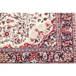 Two Persian rugs, Persian Hamadan hand-knotted rug, ivory ground centred by a terracotta medallion, surrounded by scrolling floral and foliate motifs, dark navy floral border with narrow guard stripes, fringed ends, H 176cm, W 75cm, Persian tribal hand-knotted rug, madder red ground decorated with three large geometric medallions, surrounded by angular motifs, enclosed by multiple geometric borders in dark navy, ivory and red, fringed ends, H 150cm, W 91cm