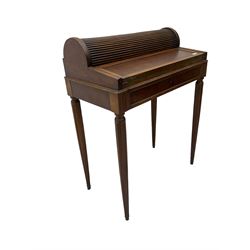 Early 20th century French plum pudding mahogany petite writing desk, barrel tambour roll top, fitted with a single cock-beaded drawer activating the tambour roll, the fold-over writing slope with inset writing surface supported by long drawer, fitted with three small drawers and pen rail, raised on fluted tapering supports