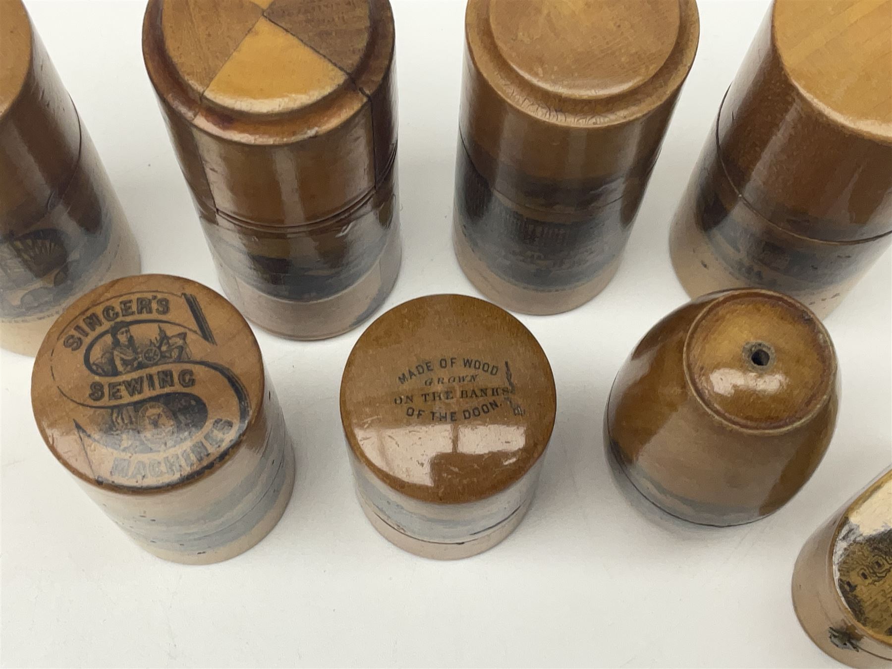 Collection of Mauchline ware relating to sewing, to include four ovoid shaped thimble cases, hinged lid thimble case and needle cases (12) 