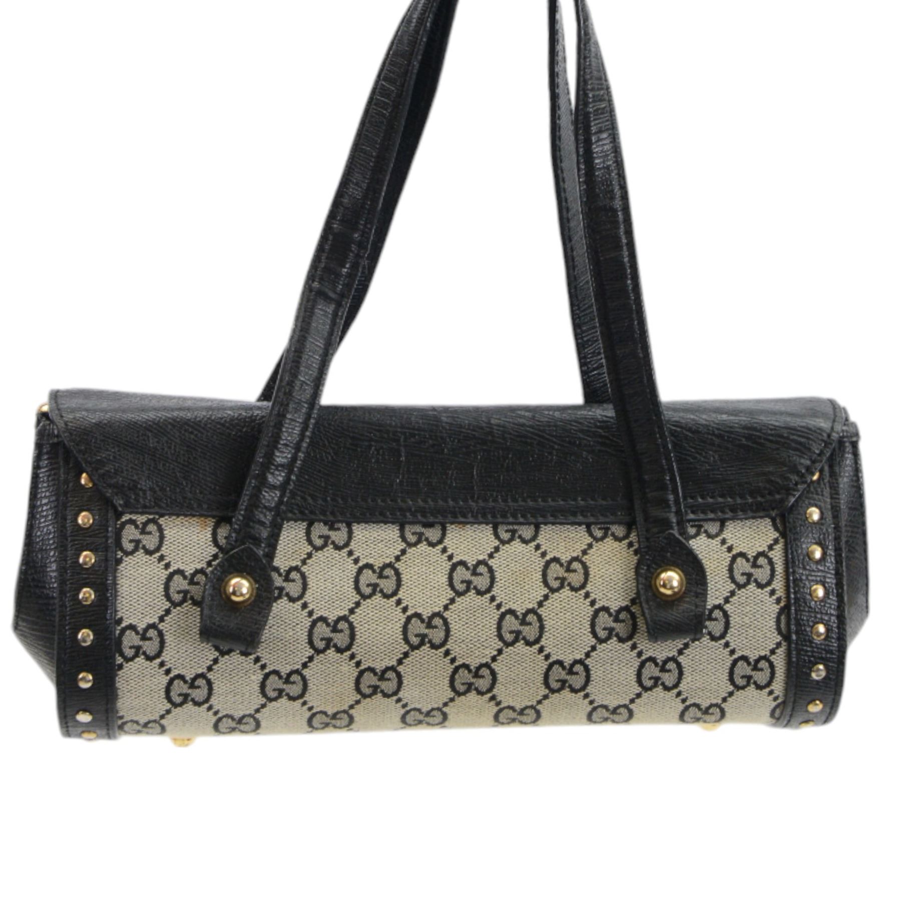 Gucci 'Bamboo Bullet' shoulder handbag, the canvas body with repetitive GG logo design and black studded leather border, with gold tone clasp impressed Gucci, and bamboo handle, with interior zip pocket, serial no. 910998 9019 impressed to interior leather, with Gucci satin dust bag, H14cm, W20cm