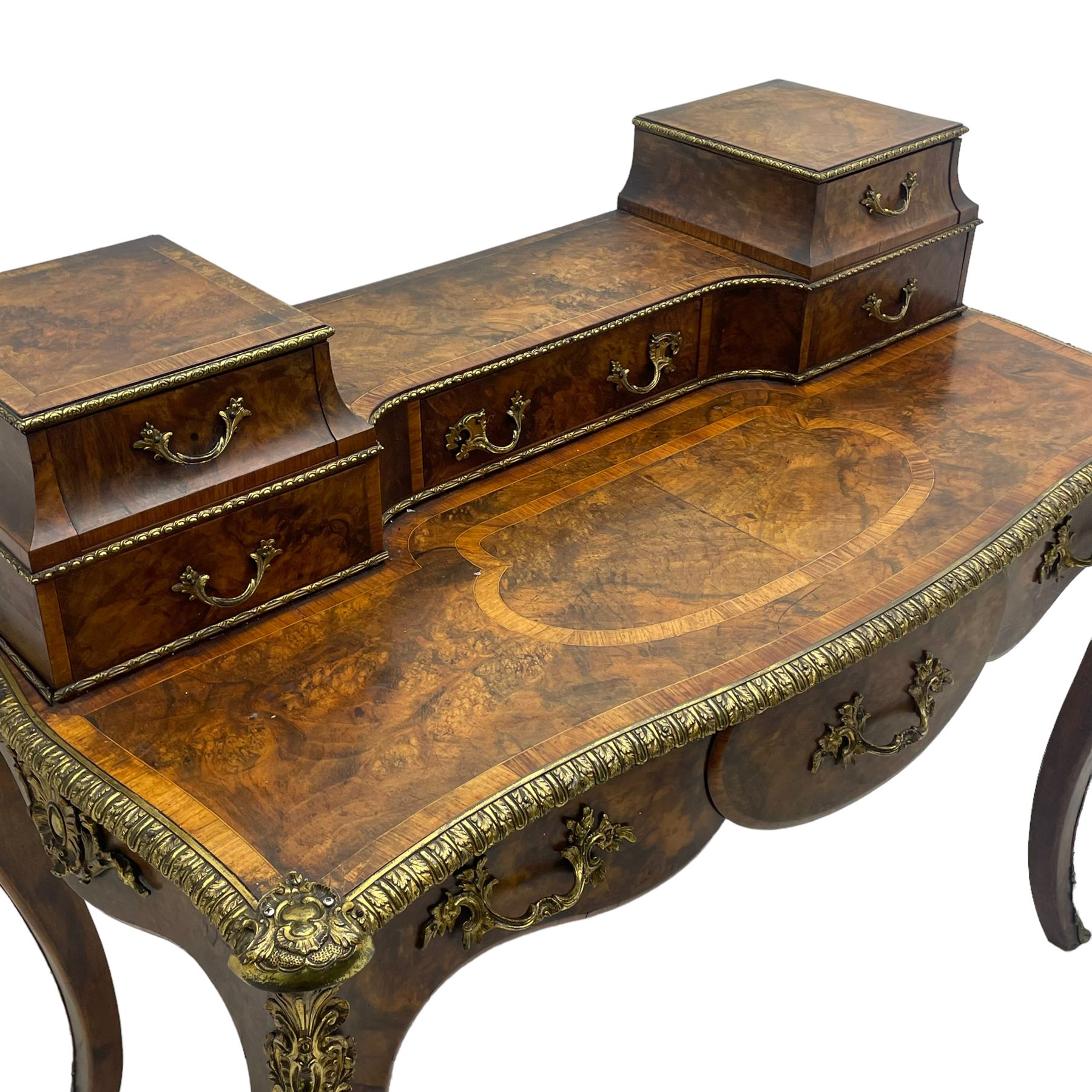 Late 19th to early 20th century French figured walnut writing desk, raised back fitted with drawers, shaped top with Kingwood banding and foliage cast edge moulding, fitted with single drawer, on cabriole supports mounted by shell and flower head cartouches 