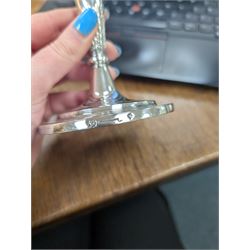 Pair of continental silver candlesticks, probably German Hanau, each of tapering form, with fern leaf decoration, upon a stepped circular base, with Hanau marks and assay scrape to base, H19cm