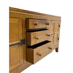 Rabbitman - adzed oak sideboard, fitted with three central drawer and two flanking cupboards, panelled doors with iron latches and hinges, carved with rabbit signature, by Peter Heap, Wetwang