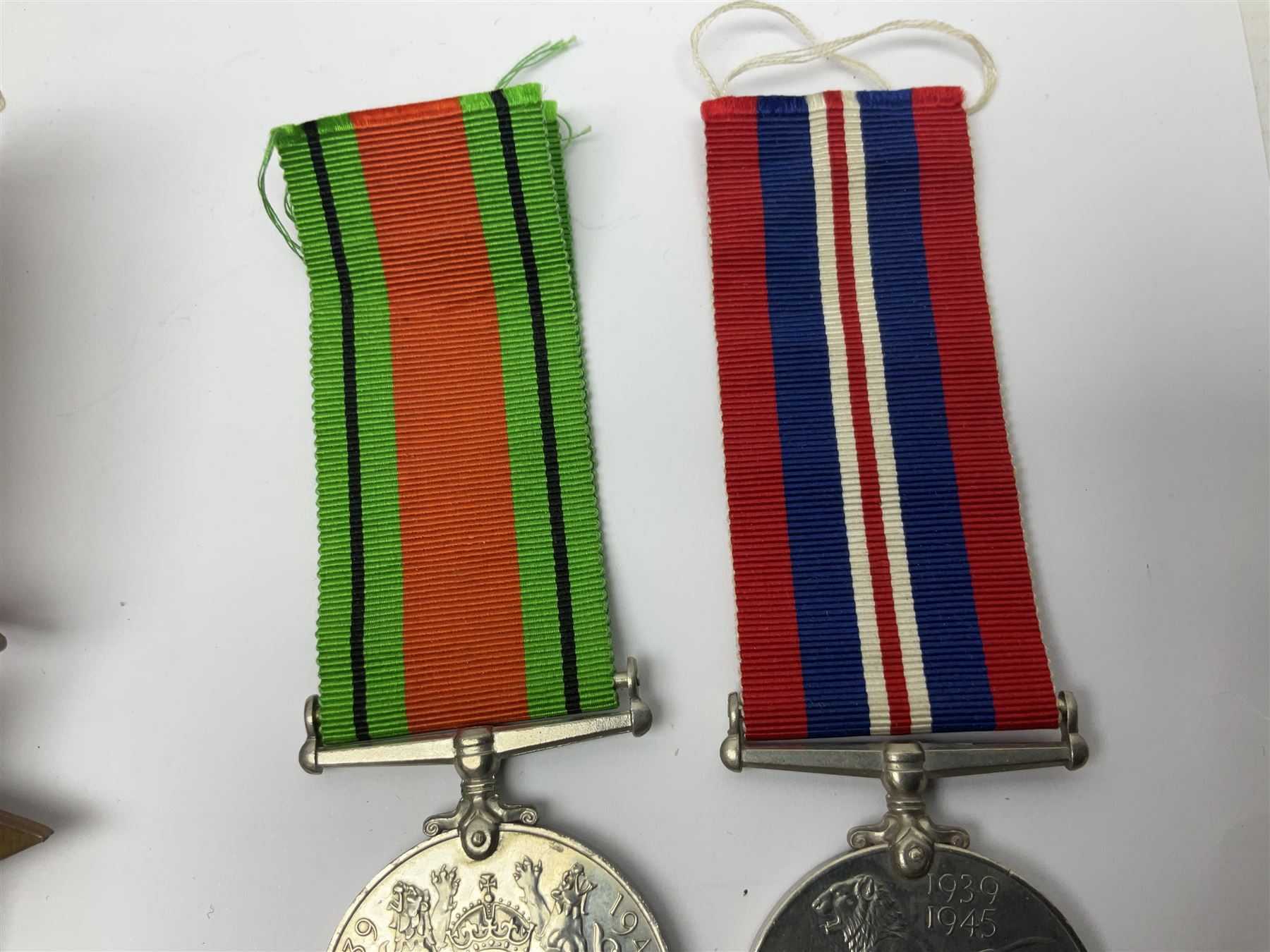 WWI pair of medals comprising British War Medal and Victory Medal awarded to 32682 Pte. W. Meadows W. Rid. R. in issue box; WWI pair of medals comprising 1914-15 Star and Victory Medal awarded to 3720 Pte. (later Cpl.) E. Petty W. York. R. with issue letter from Tank Corps; WWII group of five medals comprising 1939-45 War Medal, Defence Medal and 1939-45, Italy and Africa Stars; all with ribbons; and book of nineteen seaman's Certificates of Discharge to cook Charles Filburn 1893 - 1901 from various British ports