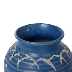 Quentin Bell 1910-1996: ribbed vase with fluted rim, decorated in white abstract design on a blue ground, signed Bell beneath, H16cm 