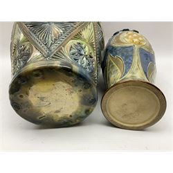 Early 20th century Royal Doulton stoneware vase, decorated with a stylized floral design below a wavy rim, monogrammed B.N, possibly for Bessie Newbery, H28cm, together with an early 20th century glazed jug, heavily carved throughout (2)