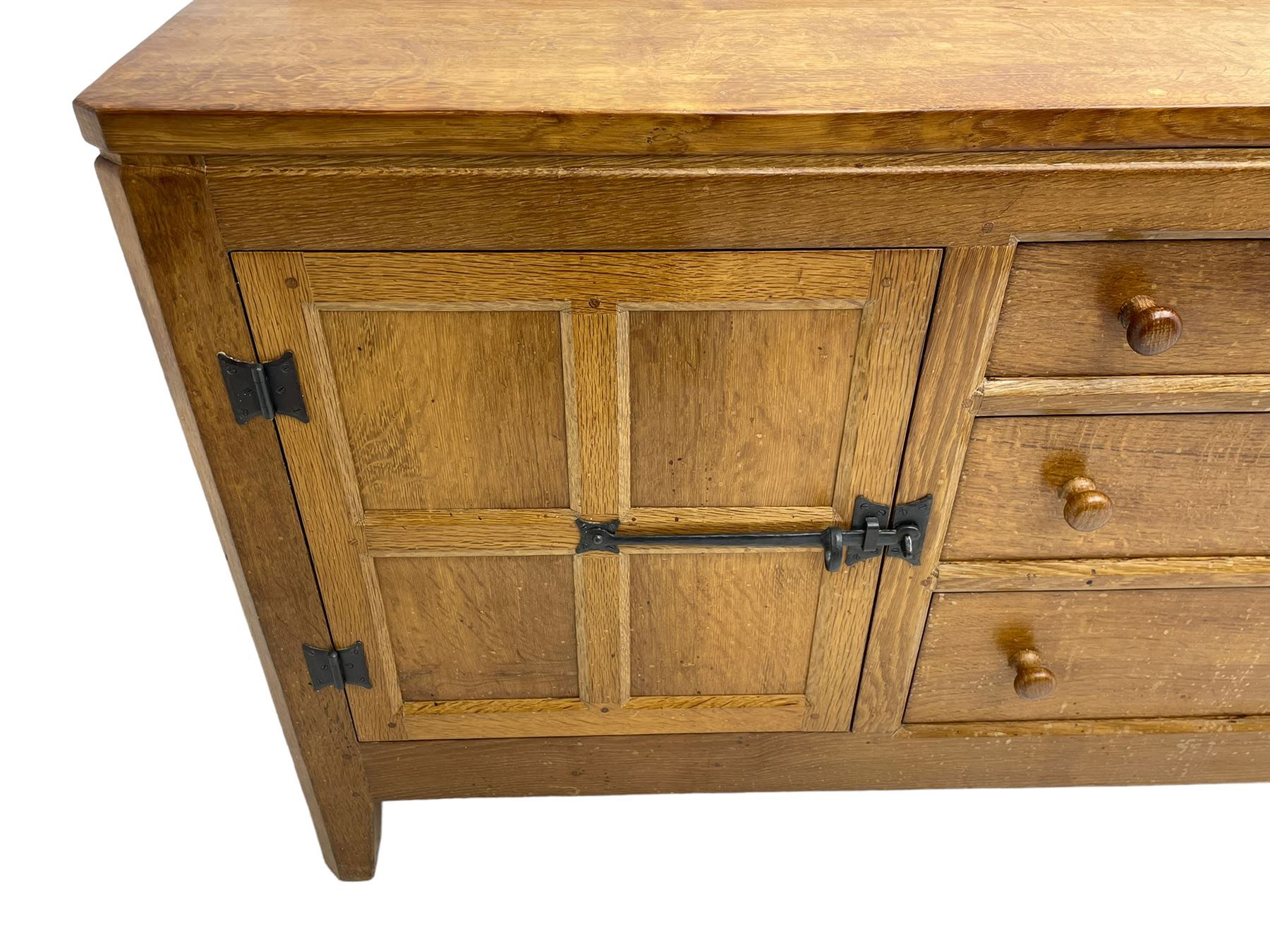 Rabbitman - adzed oak sideboard, fitted with three central drawer and two flanking cupboards, panelled doors with iron latches and hinges, carved with rabbit signature, by Peter Heap, Wetwang
