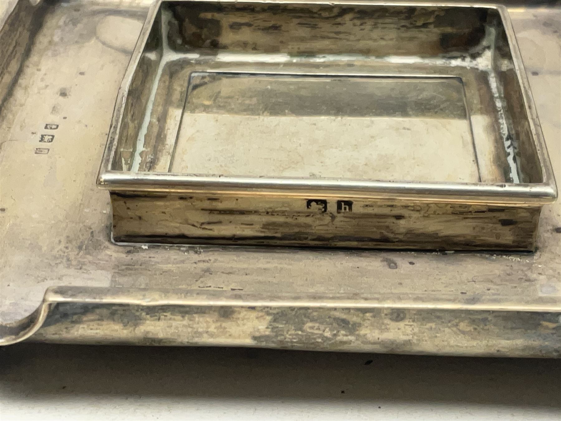 Edwardian silver stand, of square shaped form, upon four bun feet, hallmarked Birmingham 1907, together with an early 20th century silver mounted photograph frame, hallmarked Birmingham 1918, approximate weighable silver 93.6 grams