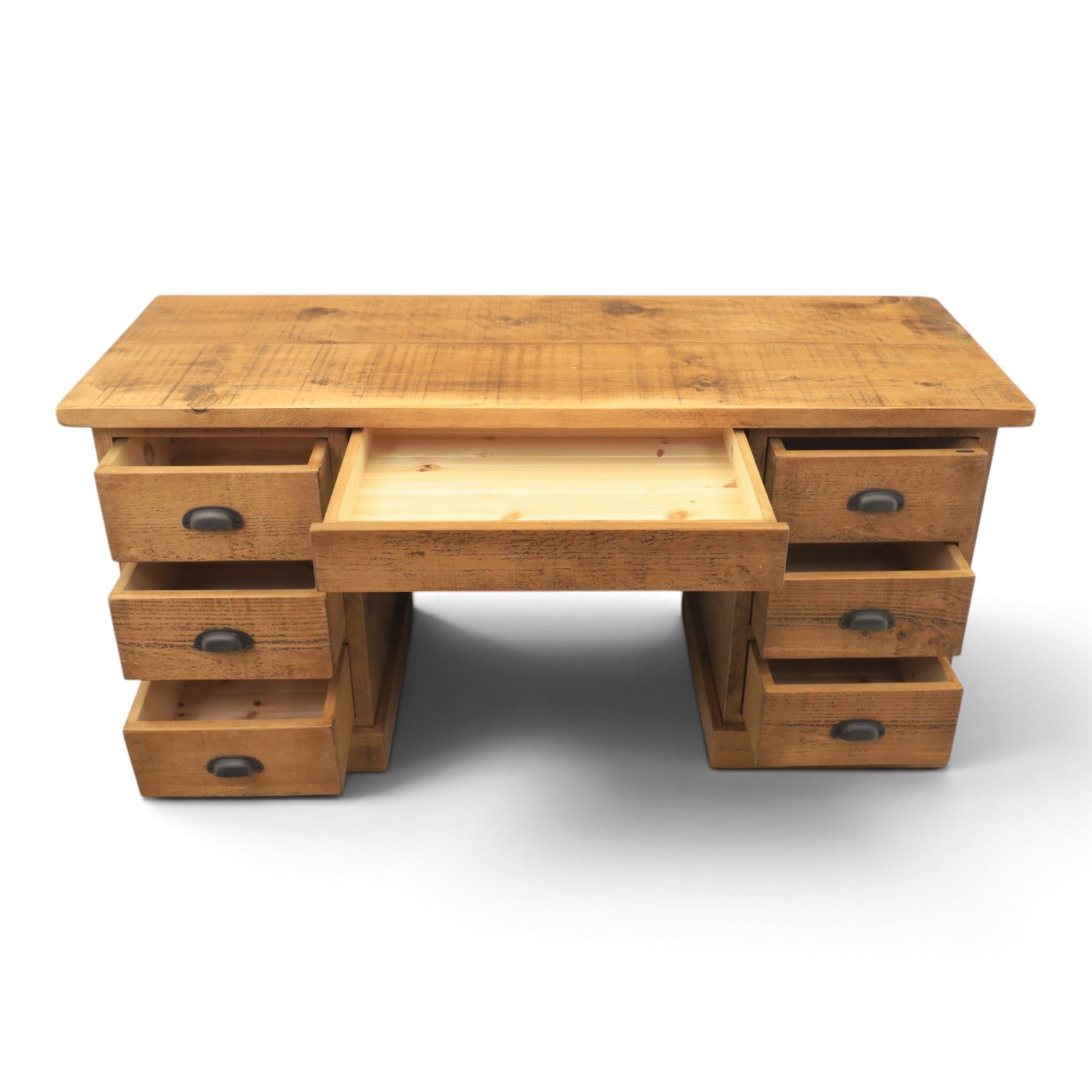 Indigo Furniture - rustic oak twin pedestal desk, rectangular plank top, with central frieze drawer, the fixed pedestals with three drawers and metal cup handles, raised on a plinth base