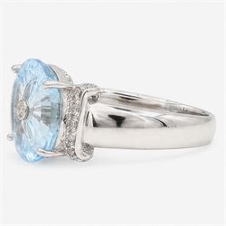 9ct white gold sky blue topaz and diamond Lehrer Torus ring, single round cut topaz of approx 5.20 carat, set with a single round cut diamond, diamond set shoulders and gallery, Birmingham 2012
