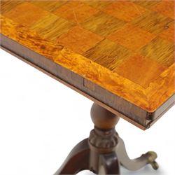 Early 20th century walnut chess table, square checkered veneered top with crossbanded edge, raise on a turned column based with acanthus craving, on three outswept legs terminating in brass paw caps above castors