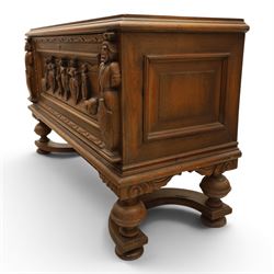 Carved oak coffer bench, rectangular moulded top above carved fall front, with figural, mask and foliate decoration, panelled sides, raised on turned bun feet with shaped lower apron