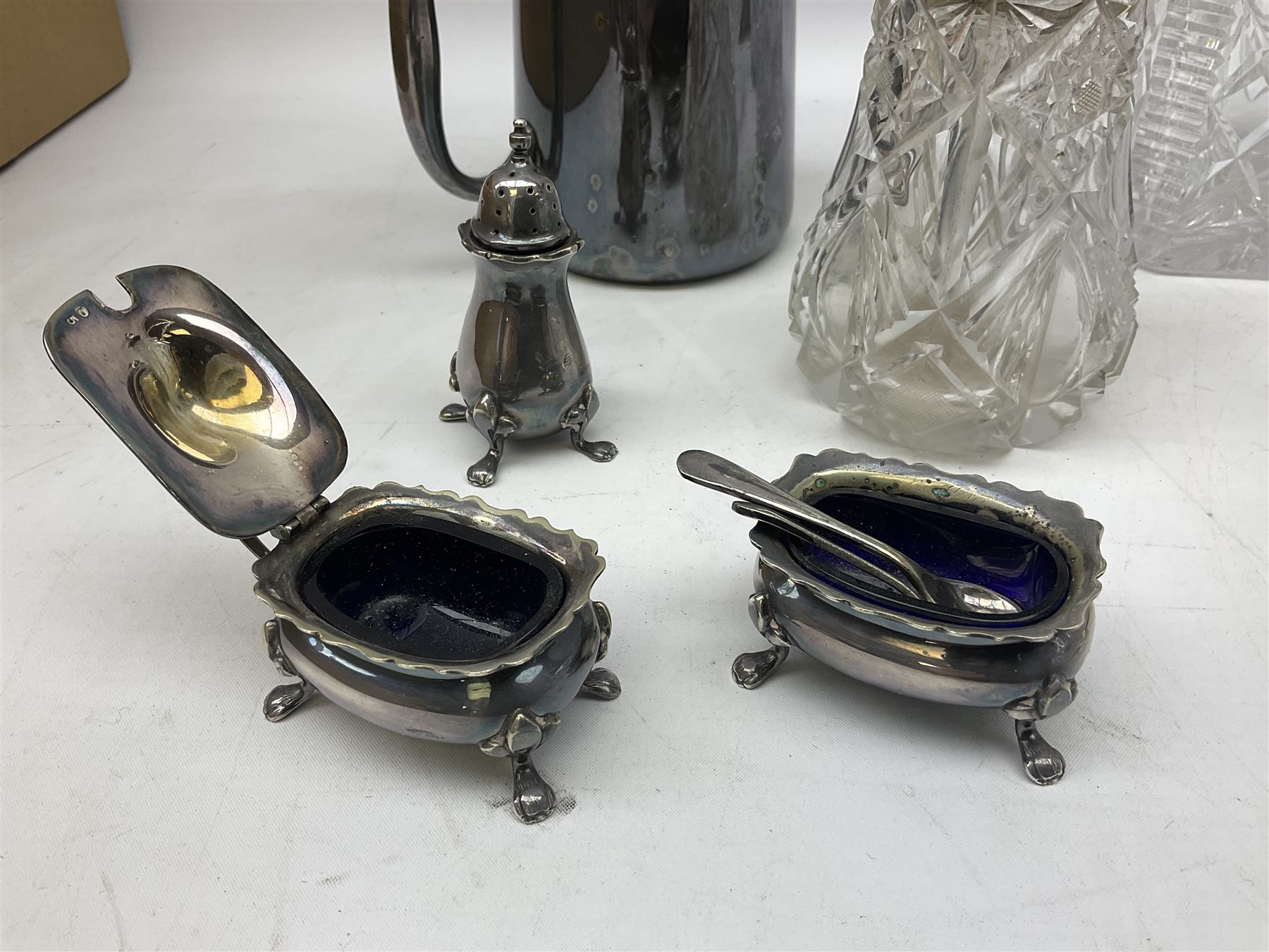 Quantity of assorted silver plated and other flatware, to include part sets, set of three silver plated cruets, glass sifter with silver plated cover, two glass decanters and stoppers, etc., in one box 