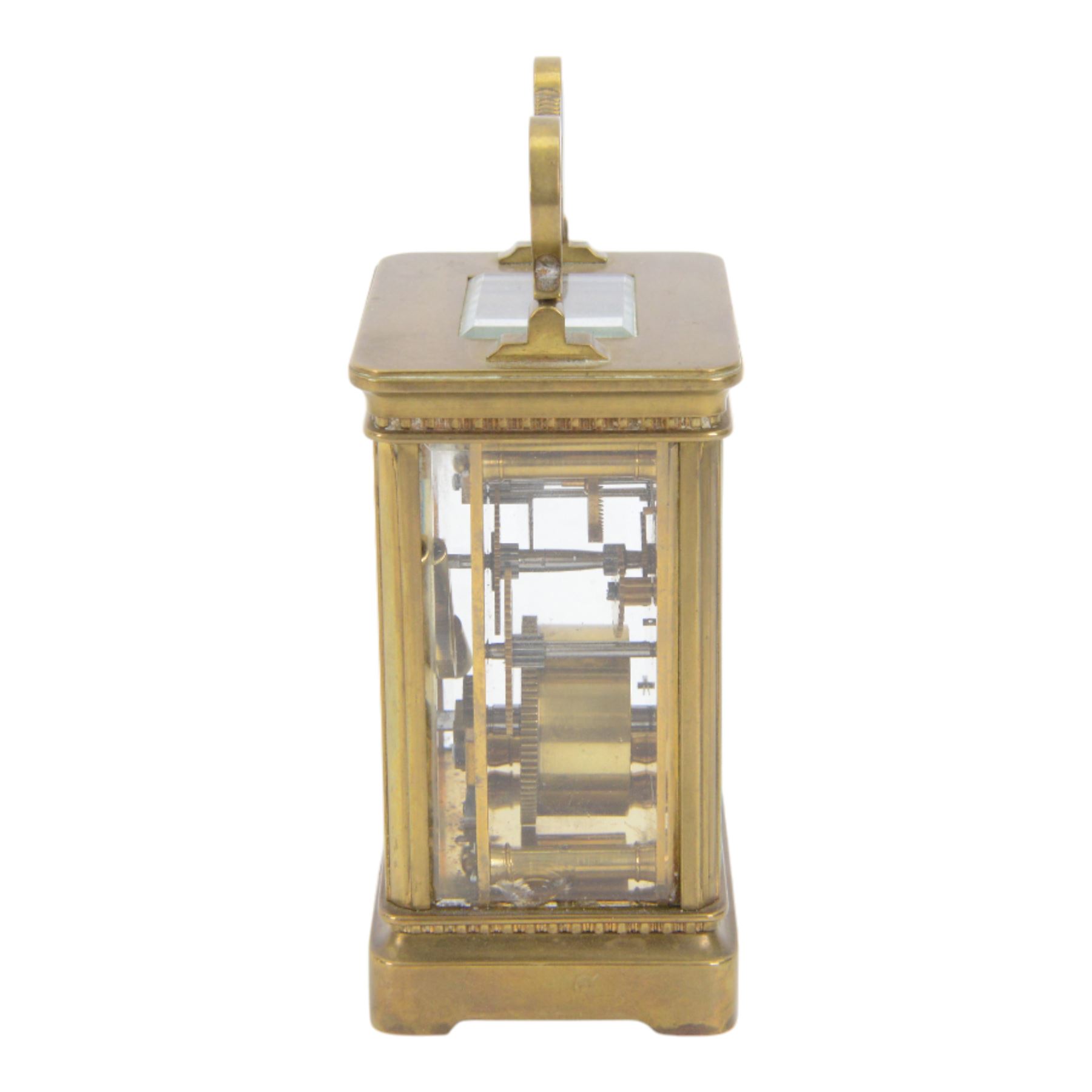 French-Edwardian 8-day timepiece carriage clock with a cylinder platform escapement, anglaise style brass case with four glass panels, dial with a polished gilt mask and foliate decoration, white enamel chapter with Arabic numerals and steel spade hands, . With Key. 