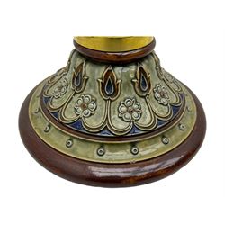 Early 20th century brass adjustable floor lamp, Royal Doulton decorative ceramic base embellished with raised floral and scroll patterns, stamped, brass column and adjustable arms terminating in brass bulb holder