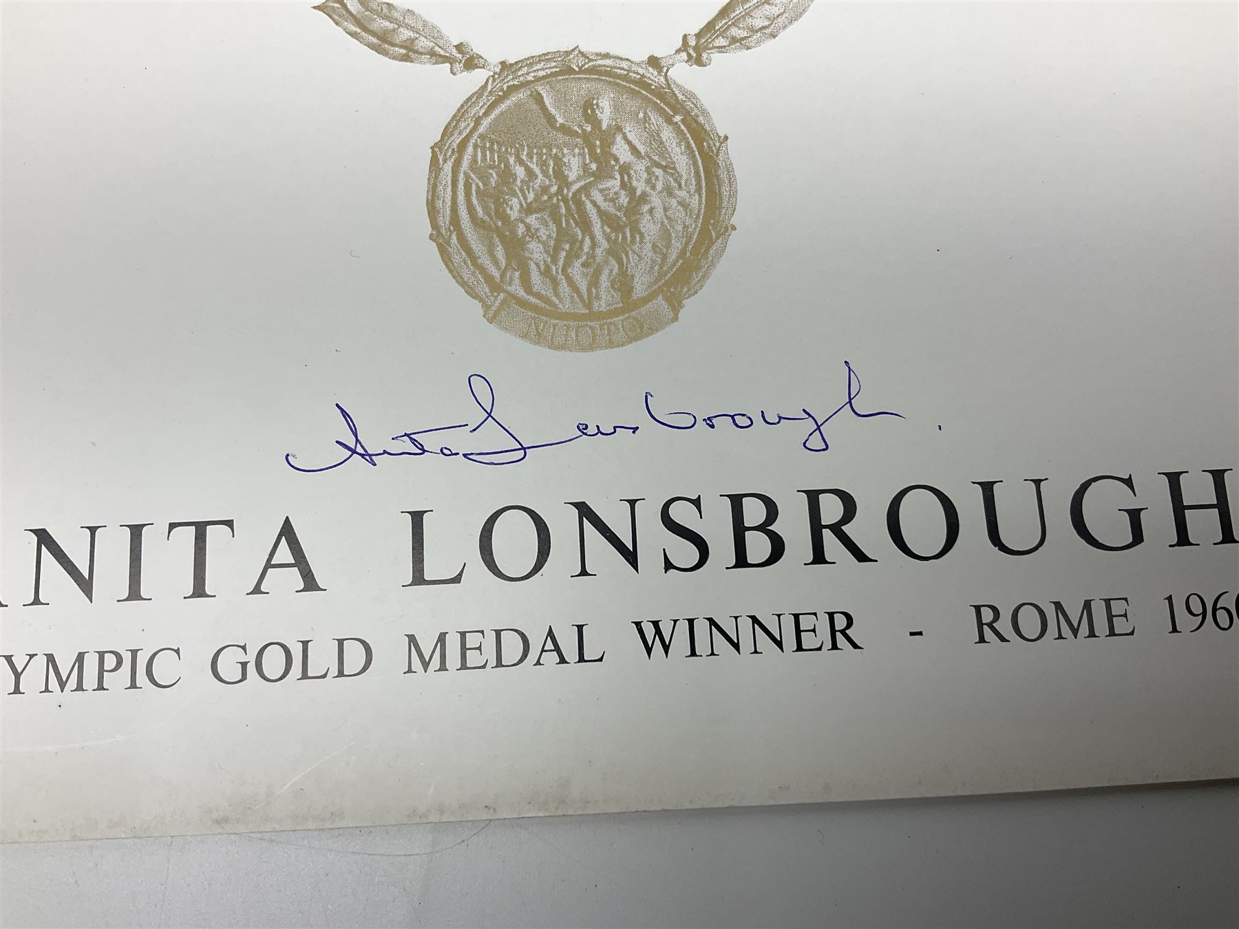 On the direct instructions of Anita Porter nee Lonsbrough Great British Olympic and Commonwealth Games gold medal winning swimmer - collection of early and international memorabilia comprising original Huddersfield Bath Club track suit top bearing eight stitched on cloth badges including British Empire & Commonwealth Games 1958 England Team, YSASA, North Eastern Counties ASA, ESSA Division 3,  English Schools Swimming Association winner etc
The swimming costume Anita wore at the 1958 Commonwealth Games in Cardiff, her first major championships, where she won two gold medals. The grey elastic on the sides, in those days, she would use to make it tighter and more streamlined.
Blue track suit from the 1960 Olympics which she wore on the podium receiving the gold medal.
1960 pool side towelling robe used at the Rome Olympics (interesting to note her name is spelt wrong on the embroidered label).
1962 Commonwealth Games pool side towelling robe used in Perth Australia when winning three Gold medals. 
It was also this year she became BBC Sports Personality of the year, the first female to do so.
Her 'lucky' pool side towel which she took with her to every event she competed in and which can be seen round her neck in many official celebratory photographs. Copies of some of these photographs are included for identification.
In addition there are two souvenir programmes of an evening event to honour Anita at The Theatre Royal Huddersfield and she has kindly signed the front cover on one of these.