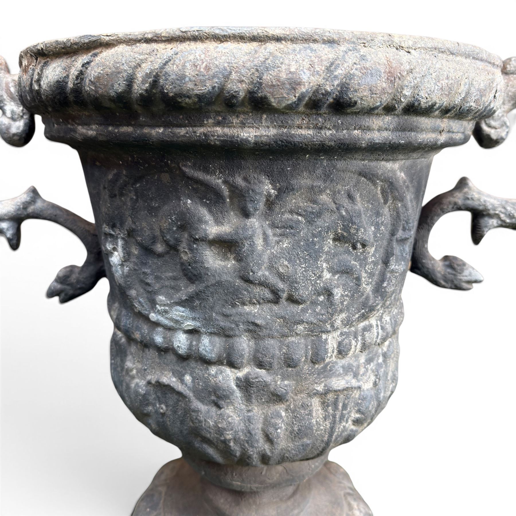 Impressive pair of early highly decorative lead garden urns, griffin handles with ornate decoration depicting cherubs and laurel wreath