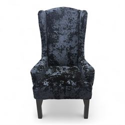 Oka - Pair of contemporary upholstered wingback armchairs, in black and blue textured velvet effect fabric, with tall scroll wing sides and square tapered legs joined by stretchers