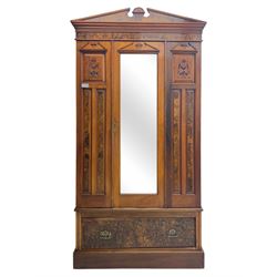Victorian walnut bedroom suite - wardrobe, dressing chest and bedside cupboard, comprising a full-length wardrobe with broken pediment and central mirrored door, large lower drawer, a matching dressing table with bevelled swing mirror over two trinket drawers and two short drawers over two long drawers, and a single-door bedside cupboard, all with moulded edges, decorative panel work and shaped aprons