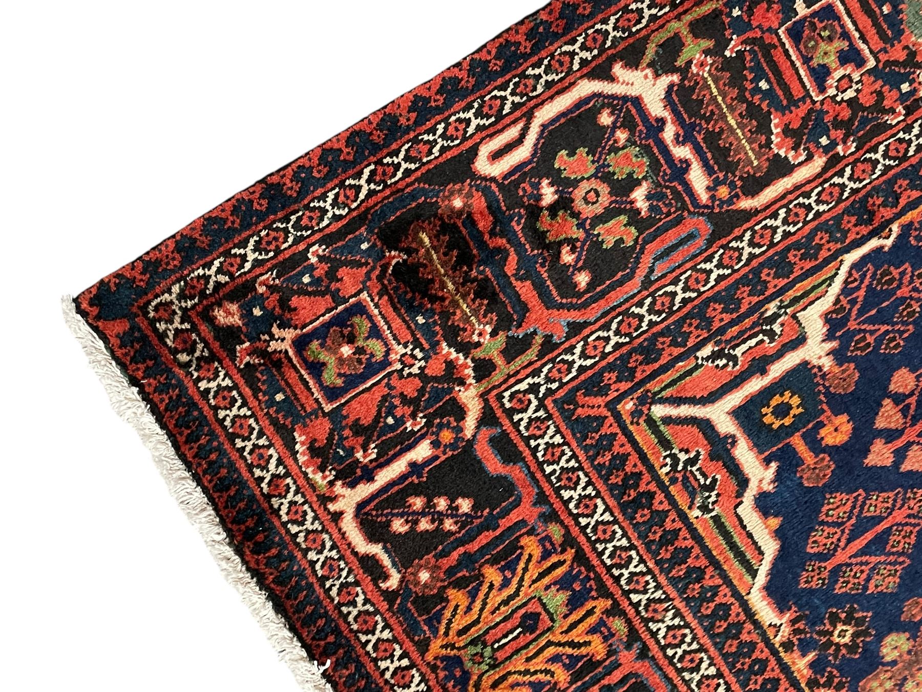 Persian Joshgan red ground rug, the medallion, field and spandrels decorated with clusters of Pitrak and tree of life motifs, the border with repeating design decorated with stylised plant motifs, within guard stripes