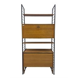 Staples Ladderax - mid-20th century teak and metal framed modular wall unit, fitted with central fall-front cupboard enclosing correspondence dividers, over secondary separate teak fall-front cupboard, adjustable shelf to top