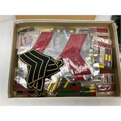 Quantity of military horse hair plumes and feather hackles, cloth stripes and regimental titles etc