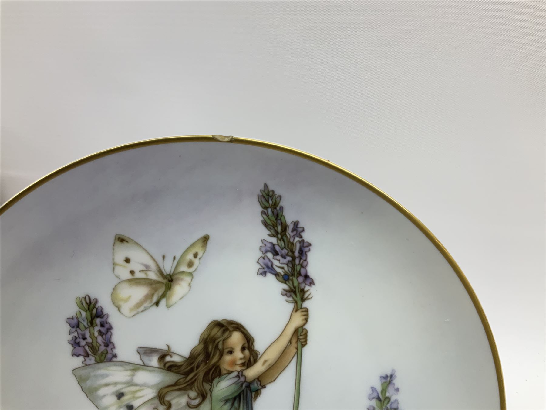 Four Royal Doulton Images figures comprising 'Happy Anniversary', 'Wedding Day', 'Congratulations' and 'Carefree', together with a set of three Heinrich collectors plates depicting Fairies.