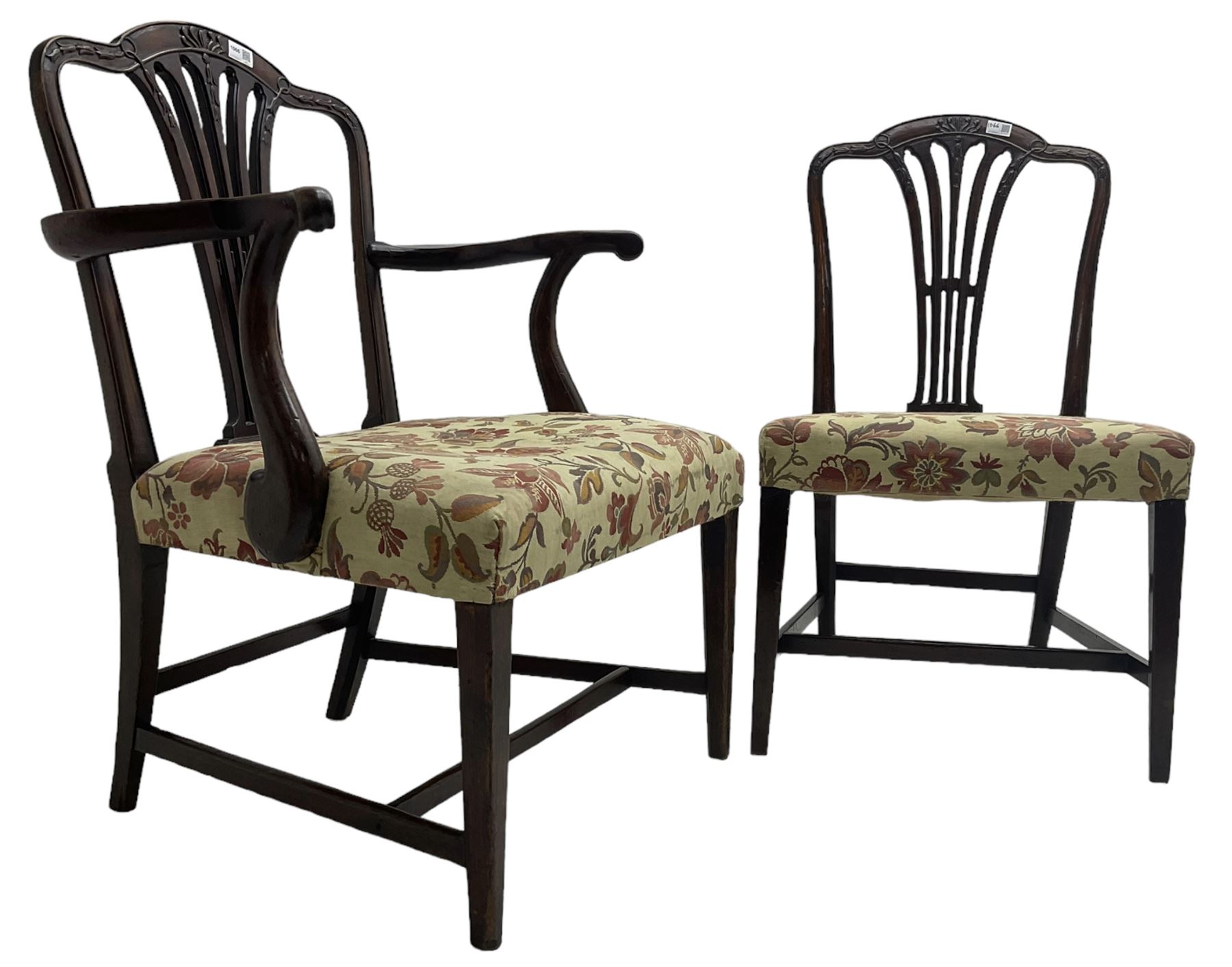 George III Hepplewhite design mahogany elbow chair and matching side chair, cresting rail carved with bellflowers over pierced and flared splat, seats upholstered in floral patterned fabric, raised on square tapering supports united by stretchers