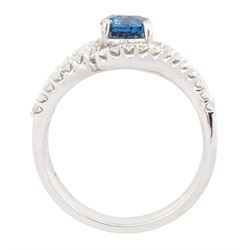 18ct white gold diamond crossover ring, the principal round brilliant cut fancy blue diamond of approx 0.75 carat, with round brilliant cut diamond surround and shoulders, stamped 750, total white diamond weight approx 0.60 carat