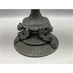Victorian cast spelter oil lamp, decorated with cherubs and foliate scrolls, supporting a glass reservoir, burner and clear glass chimney, H62cm