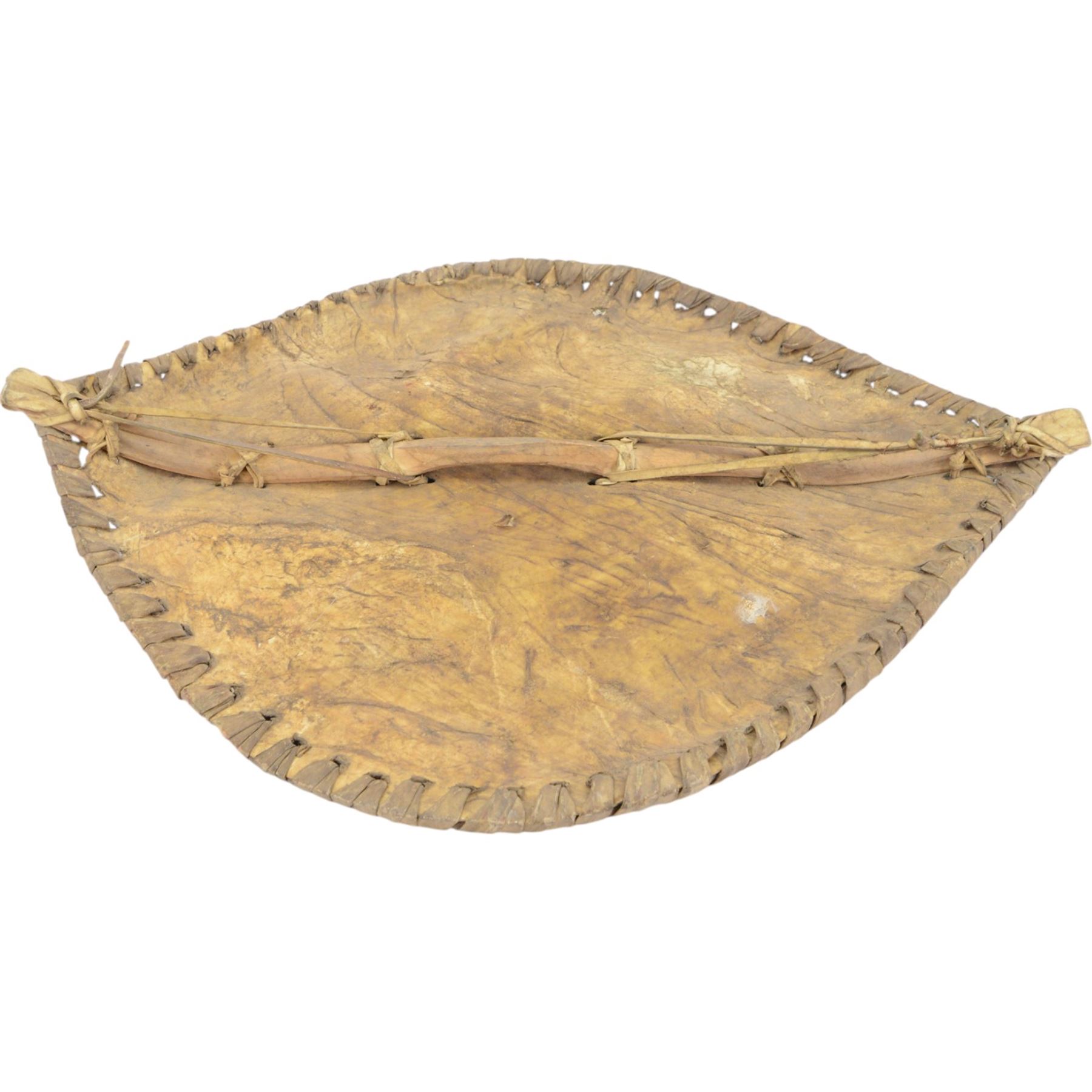 Maasai shield, made of hide, with white, red and black pigment decoration, the back attached to a wooden frame with hide stitching, together with two Maasai spears, shield H70cm, spears L120cm