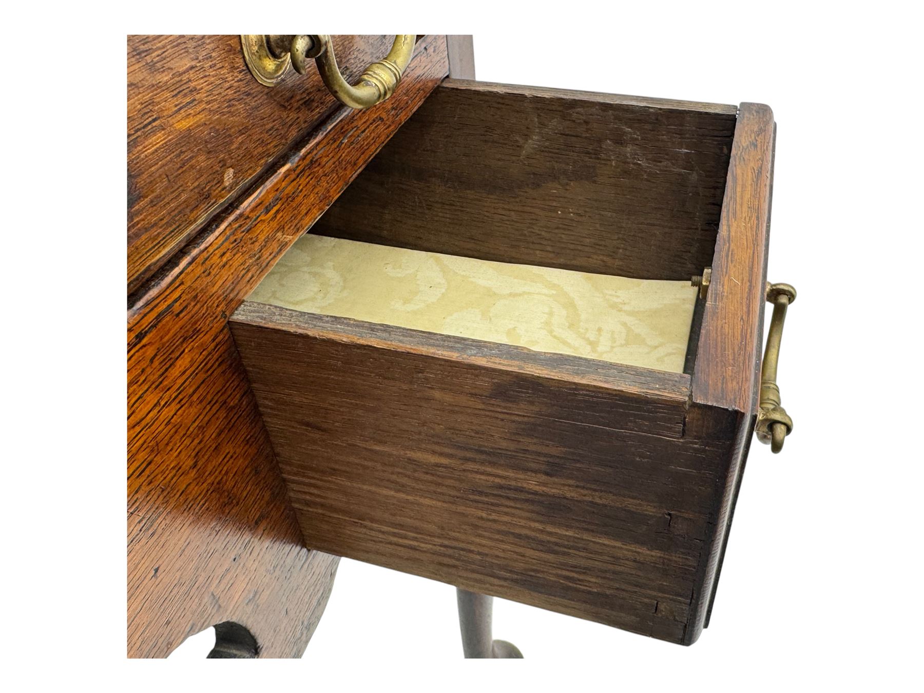 George II oak lowboy, moulded rectangular top over one long and two short drawers fitted with brass drop handles, shaped apron with scrollwork carvings, raised on cabriole supports