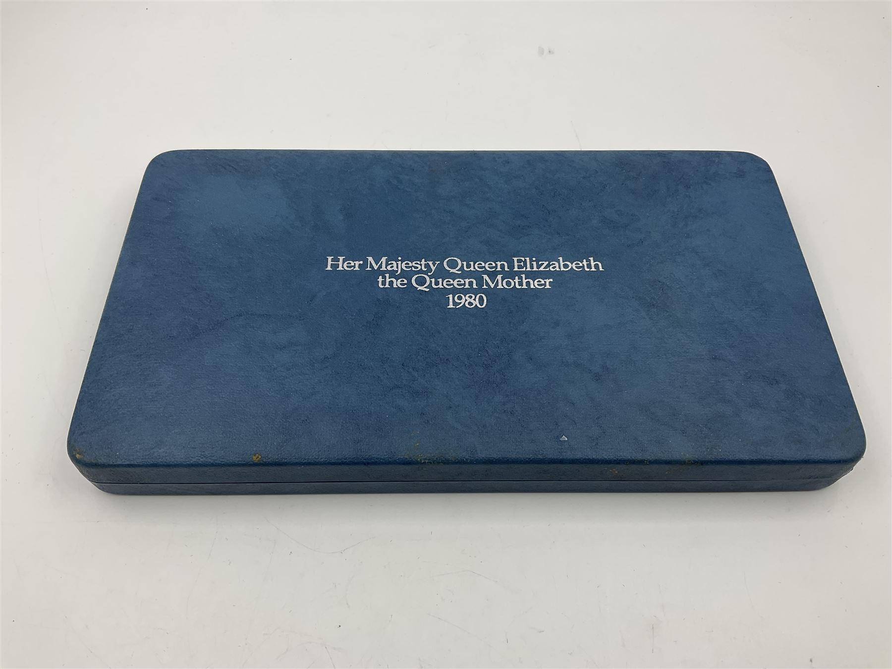 The Royal Mint silver proof seven coin set, comprising United Kingdom and six Commonwealth crowns, commemorating 'Her Majesty Queen Elizabeth The Queen Mother's 80th Birthday', cased with certificate