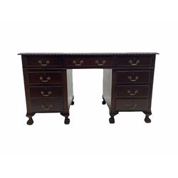 Early to mid-20th century mahogany twin pedestal desk, gardroon carved top with leather inset, fitted with nine drawers