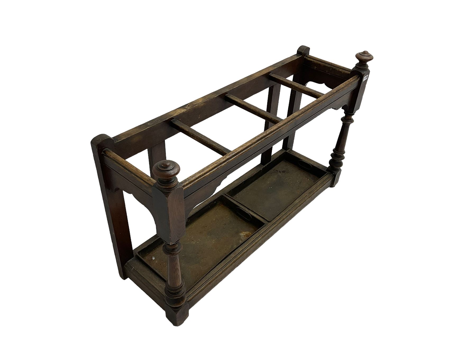 Edwardian oak hallway stick and umbrella stand, four divisions on turned supports, with metal tray liners and various sticks