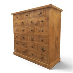 Indigo Furniture - large rustic oak combination chest, three drawers above ten drawers, with blackened pulls, raised on a plinth base