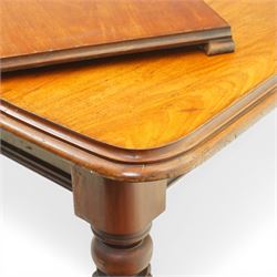 Victorian mahogany extending dining table, rounded rectangular top with moulded edge and two additional leaves, on four turned and fluted supports with brass caps and castors, extension mechanism beneath, in need of restoration