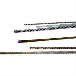 Six Victorian glass walking canes, to include three 'frigger' examples with colour twist designs, a 'hundreds and thousands' example with knop finial and filled with micro beads, possibly Nailsea, an opaque green twist example, and an amber glass example, longest L130cm