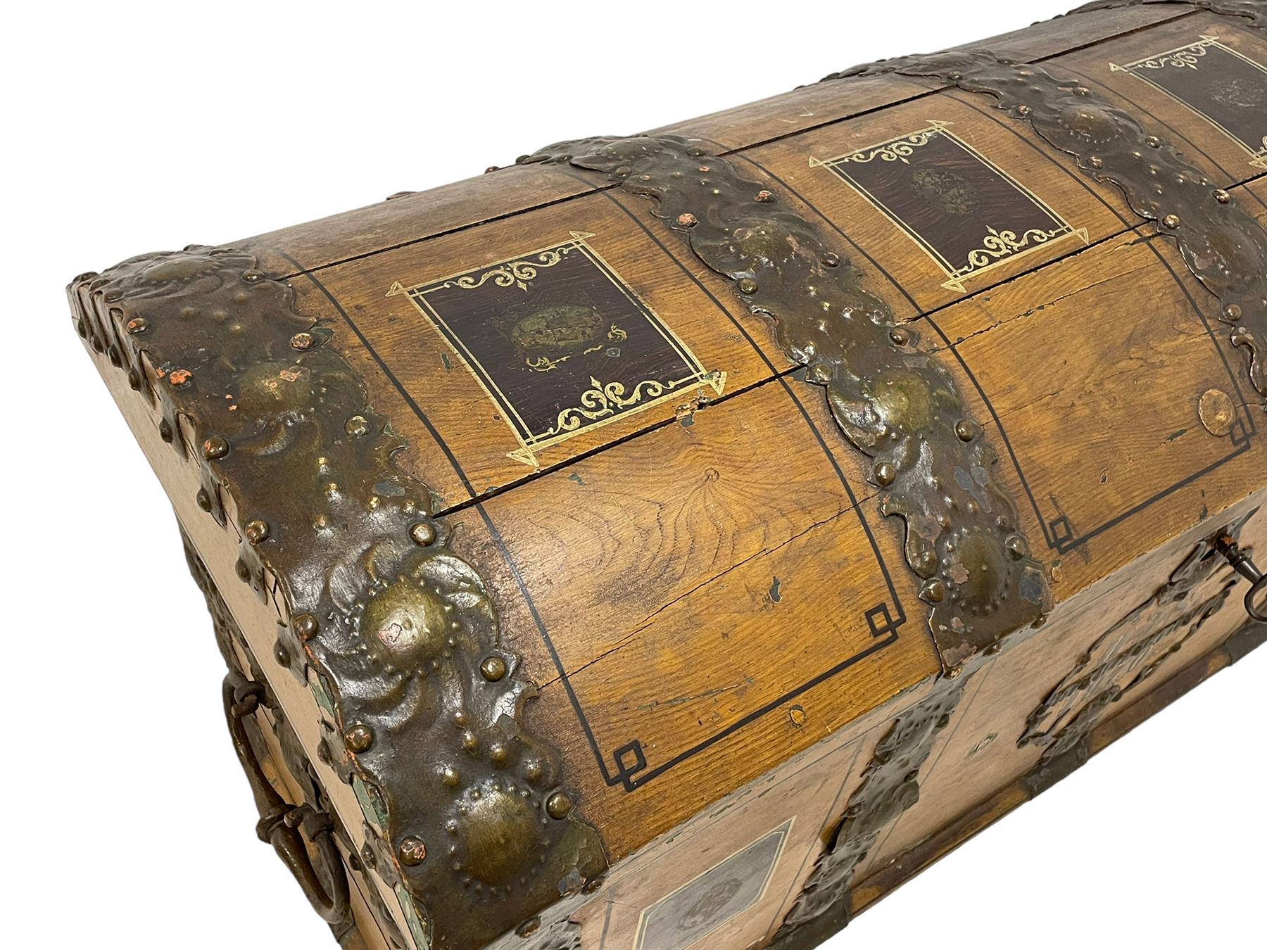 19th century painted oak sea chest, hinged dome top enclosing small compartment, bound by shaped and pressed metal strapwork, scumbled finish to resemble oak and painted with small vignettes depicting portraits and landscapes within panels, fitted with large wrought metal carrying handles, the front inscribed 'H.J.S. 1870' 