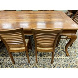Large teak dining table, moulded rectangular top, on cabriole supports, together with a set of ten ladder back dining chairs with cane work seats