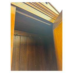 Victorian walnut bedroom suite - wardrobe, dressing chest and bedside cupboard, comprising a full-length wardrobe with broken pediment and central mirrored door, large lower drawer, a matching dressing table with bevelled swing mirror over two trinket drawers and two short drawers over two long drawers, and a single-door bedside cupboard, all with moulded edges, decorative panel work and shaped aprons