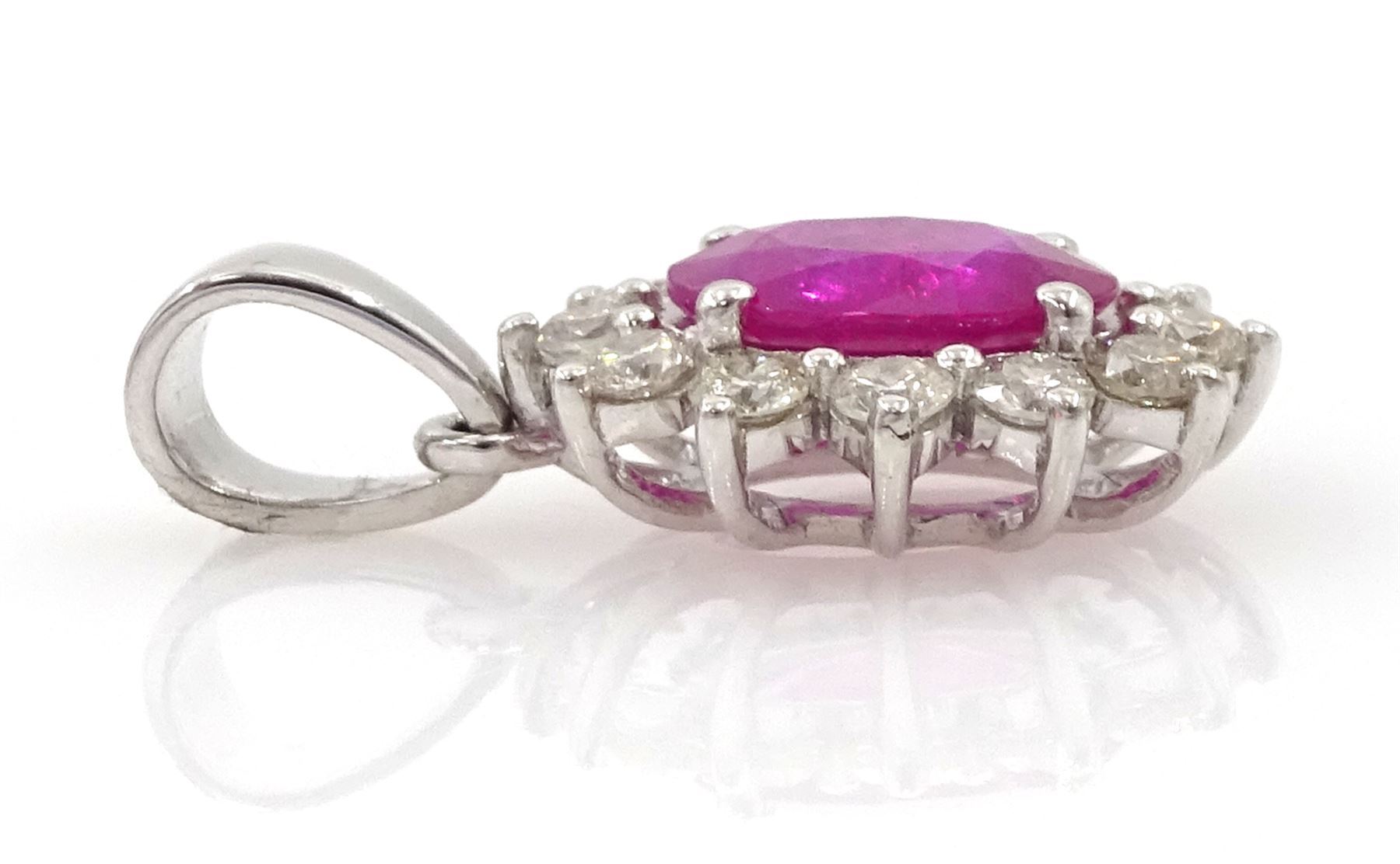 18ct white gold ruby and diamond pendant, single oval cut ruby of 1.15 carat surrounded by twelve round brilliant cut diamonds, stamped, total diamond weight approx 0.40 carat