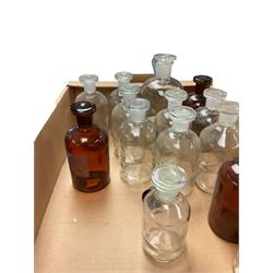 Collection of glass chemical bottles including amber glass examples