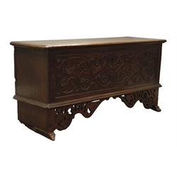  Planked oak coffer with hinged cover, the front carved in 17th century style with birds amidst scrolled branchwork, the elongated supports with pierced corner brackets and sledge feet, W146, H73cm, D52cm  
