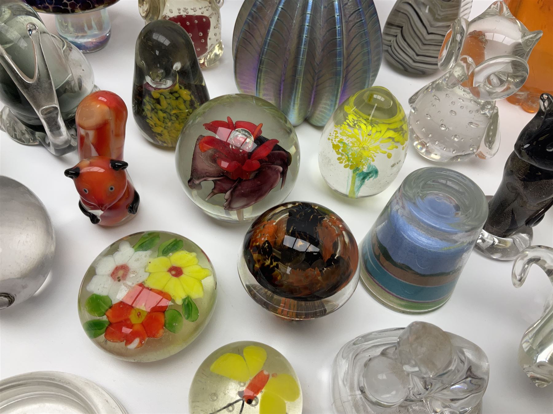 Robert Held iridescent art glass sea urchin paperweight, signed to underside, together with Murano glass clown and a collection of other glass paperweights and animals, etc 