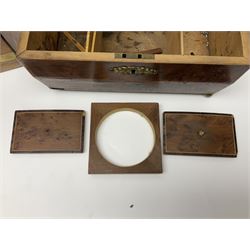 19th century burr yew wood tea caddy, of sarcophagus form, with strung details and brass mounts, the interior split into three compartments, upon four brass bun feet, together with an oak and brass bound writing slope, with red leather interior with gilt detailing, largest H16cm, W40cm