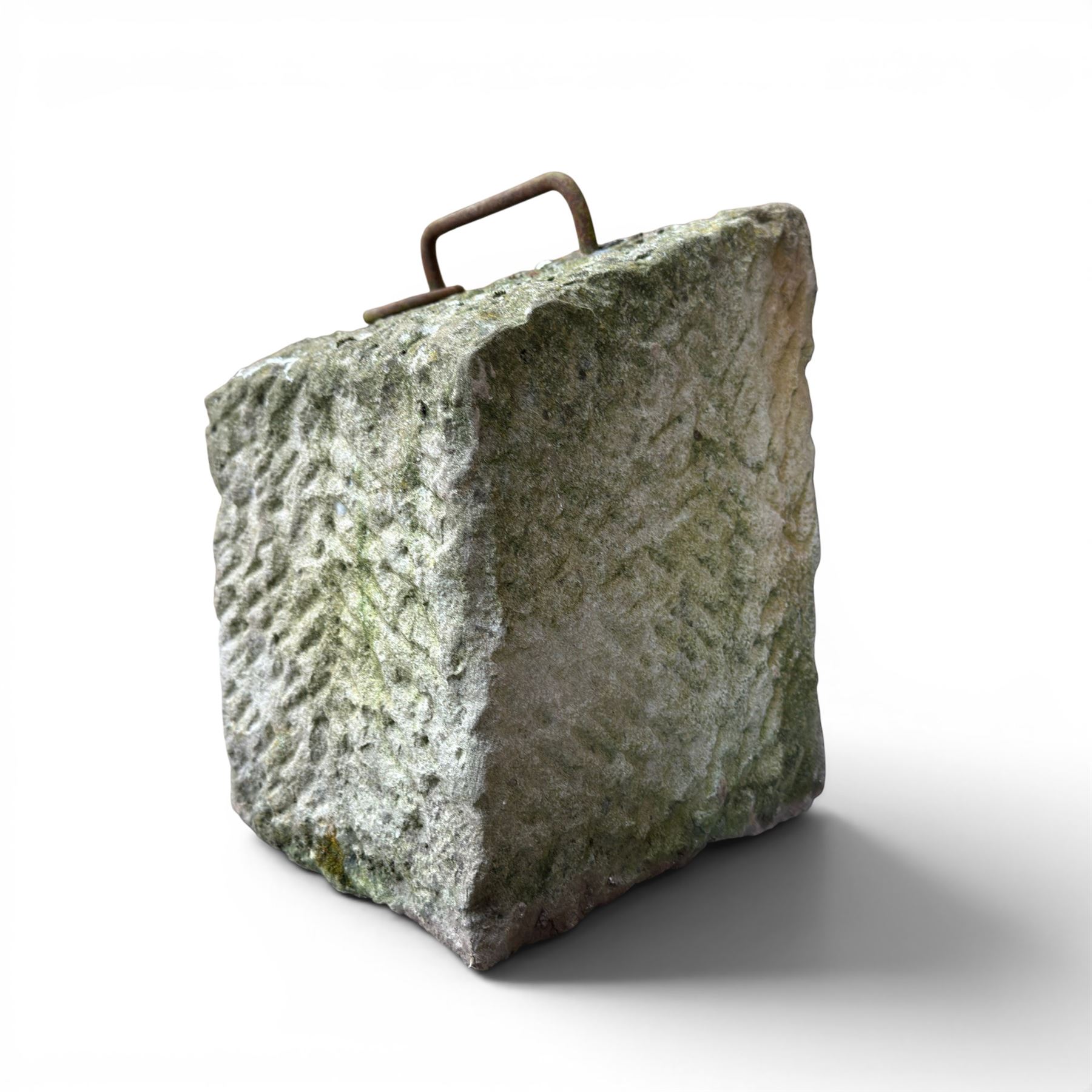 19th century carved tethering stone, square sloping form with iron work loop