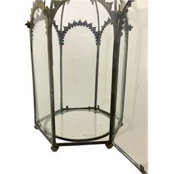 19th century brass and clear glass hexagonal hall lantern, with scrolling wire work open domed top over six arched panels, including a hinged door, the base enclosed with a circular glass panel on turned feet, H64cm