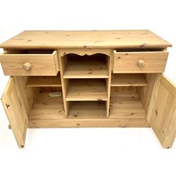 Solid pine farmhouse style dresser, two drawers and two cupboards flanking two adjustable shelves on plinth base